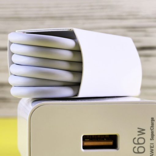 A close up of a cell phone charger on a table, illustrating an arrest for smuggling a phone into prison