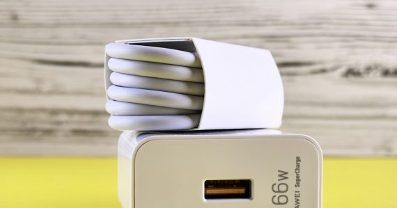 A close up of a cell phone charger on a table, illustrating an arrest for smuggling a phone into prison