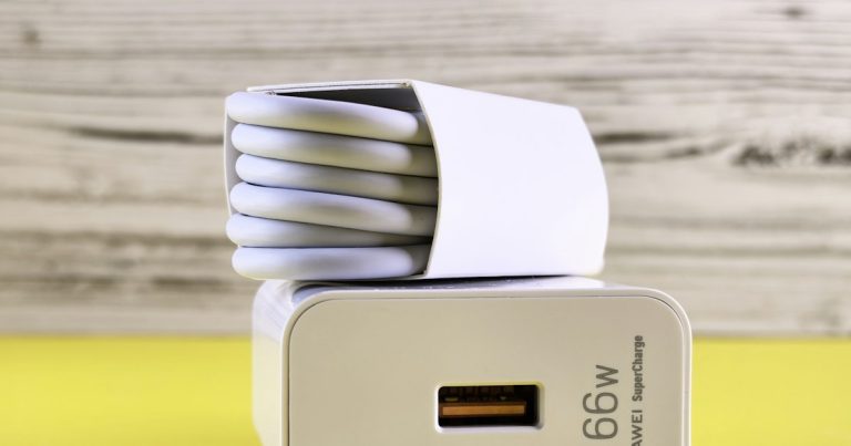 A close up of a cell phone charger on a table, illustrating an arrest for smuggling a phone into prison