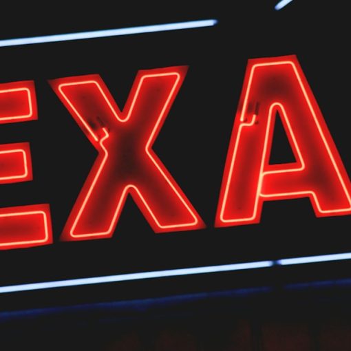 Red Texas neon light sign, illustrating phones and prisoner rehabilitation