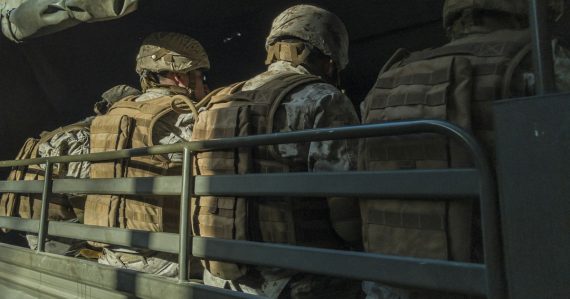 Soldiers in truck, illustrating donating confiscated phones to soldiers