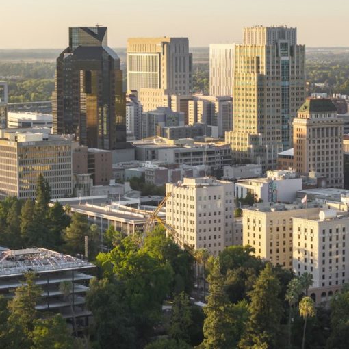 City skyline with modern buildings at sunset, illustrating California's new push against prison phones