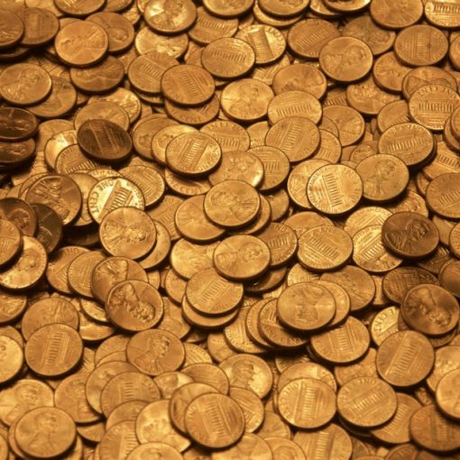 Brown round coins on brown wooden surface, illustrating wireless airtime as prison currency