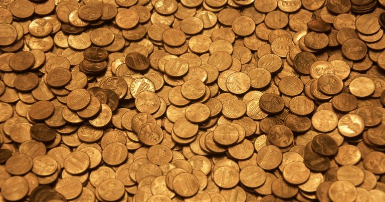 Brown round coins on brown wooden surface, illustrating wireless airtime as prison currency