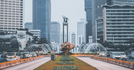 The Selamat Datang Monument surrounded by skyscrapers in Jakarta, illustrating jammers in a Jakarta prison