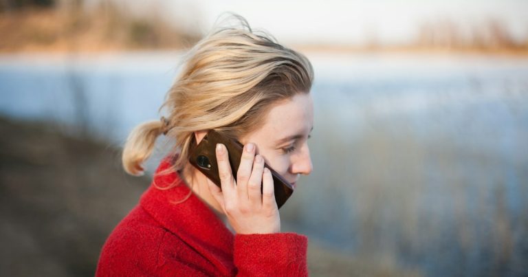 Woman taking phone call, illustrating a contraband phone ending a riot