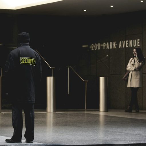 Security guard standing on the gray floor, illustrating a prison shakedown finding phones