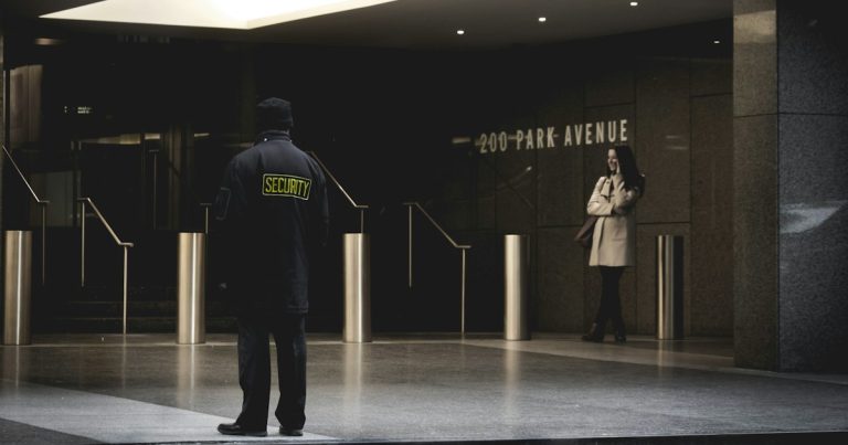 Security guard standing on the gray floor, illustrating a prison shakedown finding phones