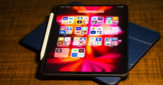 A tablet computer sitting on top of a wooden table, illustrating prison tablet news roundup