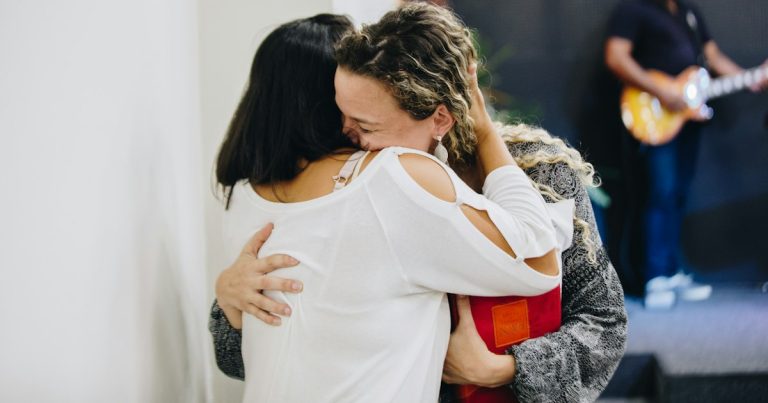 A couple of people that are hugging each other, illustrating visitation and recidivism research