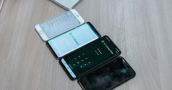 Three cell phones sitting next to each other on a table, illustrating phones confiscated in the Bahamas