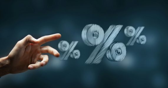 Hand reaching towards floating percentage symbols, illustrating Michigan prison phone rate increase