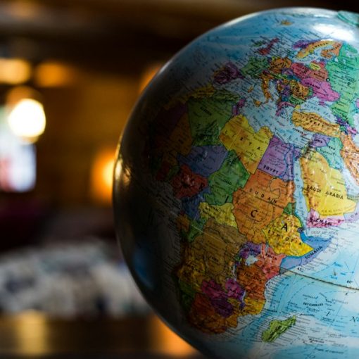 Desk globe on table, illustrating prisons and phones around the world