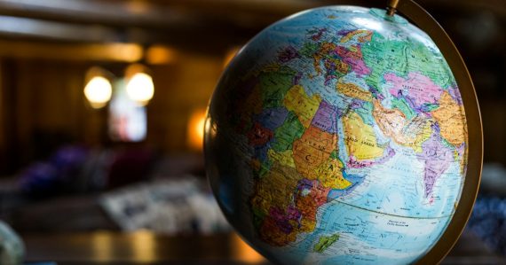 Desk globe on table, illustrating prisons and phones around the world