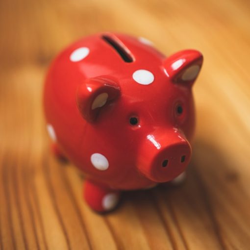 Pink and black ceramic piggy bank, illustrating the cost of underfunding prisons