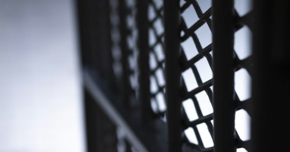 A close up view of a metal fence, illustrating a failed program to stop phone smuggling