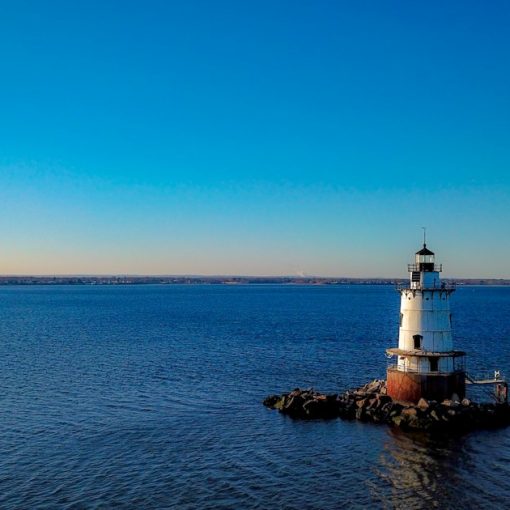 A lighthouse on a small island, illustrating Rhode Island banning phones in cells