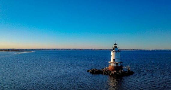 A lighthouse on a small island, illustrating Rhode Island banning phones in cells
