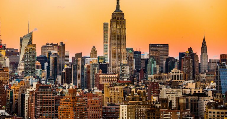 Landscape photo of New York Empire State Building, illustrating a phone-sniffing dog at Rikers