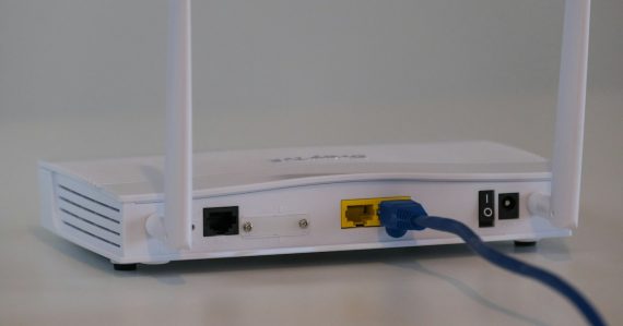White router on white table, illustrating WiFi risks in prisons