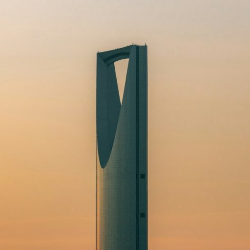 The Kingdom Centre skyscraper against a warm orange sky in Riyadh, Saudi Arabia, illustrating jammers in Saudi prisons