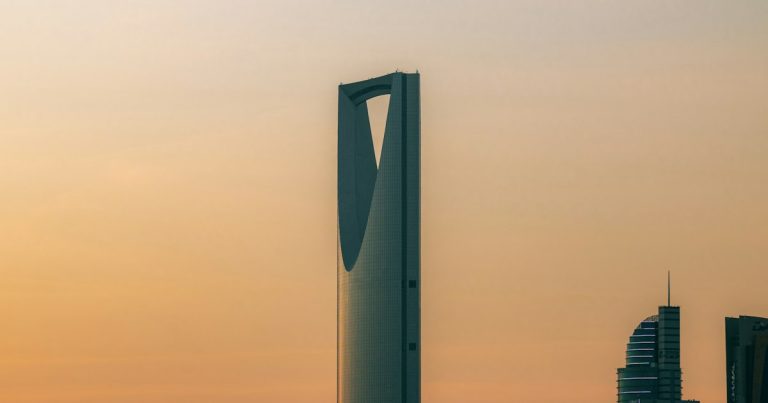 The Kingdom Centre skyscraper against a warm orange sky in Riyadh, Saudi Arabia, illustrating jammers in Saudi prisons