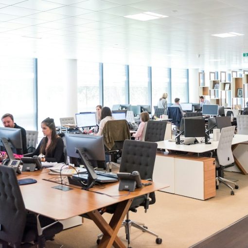 People working at desks in open office, illustrating Securus's sale to ABRY Partners