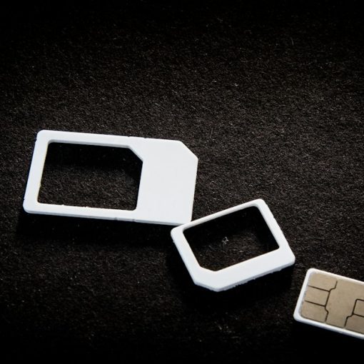 Sim cards and their adaptors are on display, illustrating detecting phones and SIM cards in prison