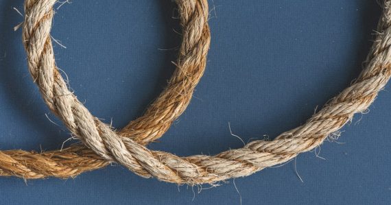 Brown rope on blue textile, illustrating a phone smuggled in with a string