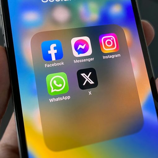 A person holding a cell phone with social media on the screen, illustrating prisoners using social media illegally