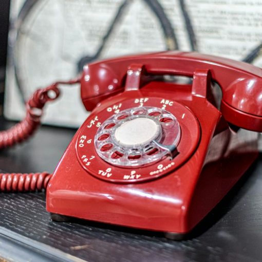 A red telephone sitting on top of a table, illustrating a prison that solved contraband phones
