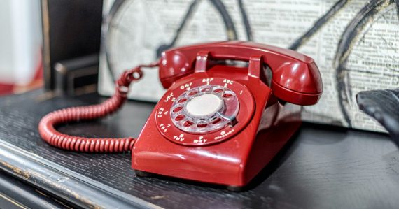 A red telephone sitting on top of a table, illustrating a prison that solved contraband phones