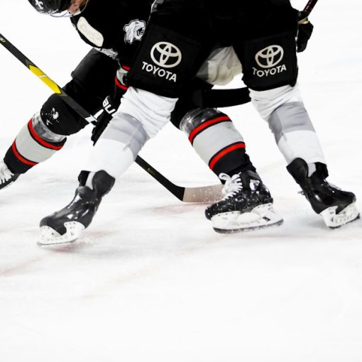 Ice hockey players on rink, illustrating innovation in inmate communications