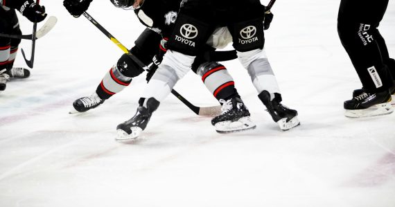 Ice hockey players on rink, illustrating innovation in inmate communications