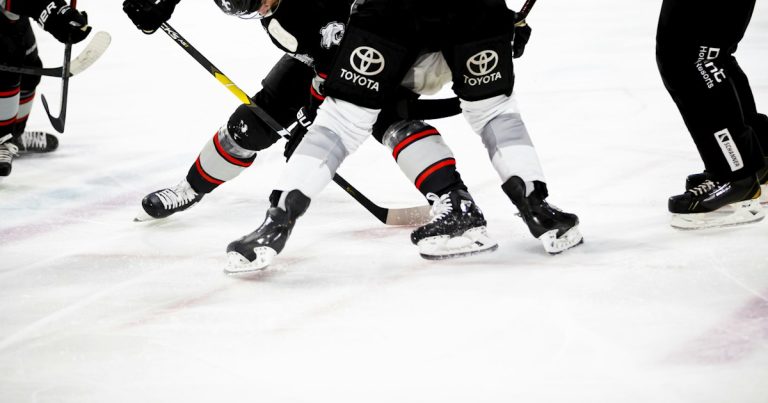 Ice hockey players on rink, illustrating innovation in inmate communications
