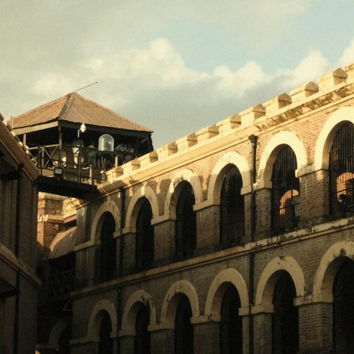 Old stone prison building with arched windows, illustrating more jammers at Tihar Jail