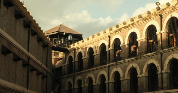 Old stone prison building with arched windows, illustrating more jammers at Tihar Jail