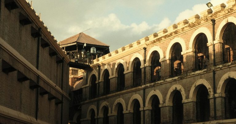 Old stone prison building with arched windows, illustrating more jammers at Tihar Jail