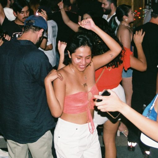 A group of people dancing at a party, illustrating an investigation into a prison toga party