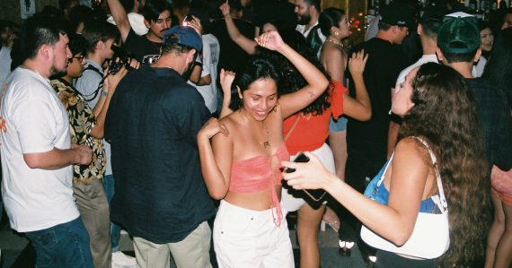 A group of people dancing at a party, illustrating an investigation into a prison toga party