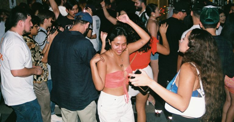 A group of people dancing at a party, illustrating an investigation into a prison toga party