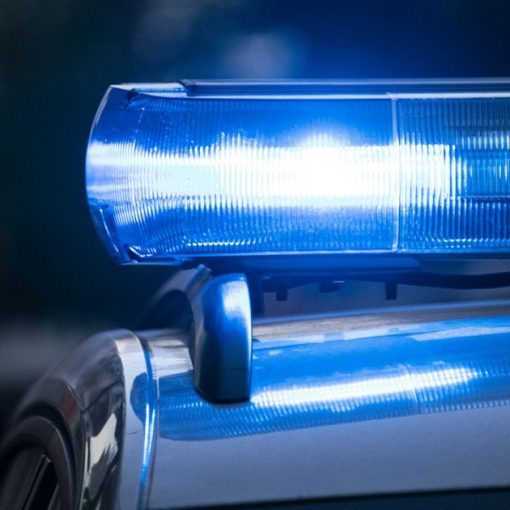 A close up of a police car with its lights, illustrating a traffic stop uncovering contraband