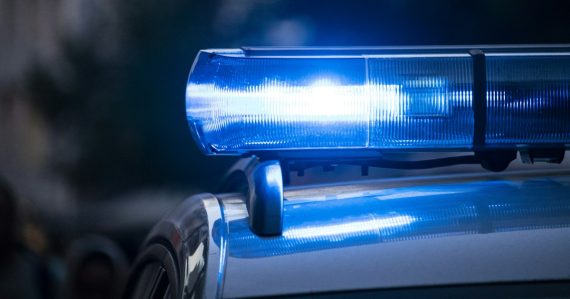A close up of a police car with its lights, illustrating a traffic stop uncovering contraband