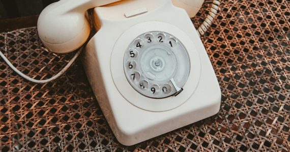 White and beige rotary telephone, illustrating a UK trial of phones in cells