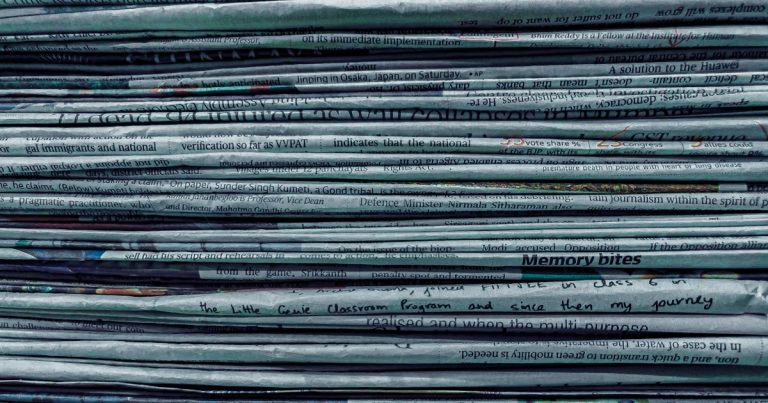 Pile of newspapers, illustrating contraband phone news briefs